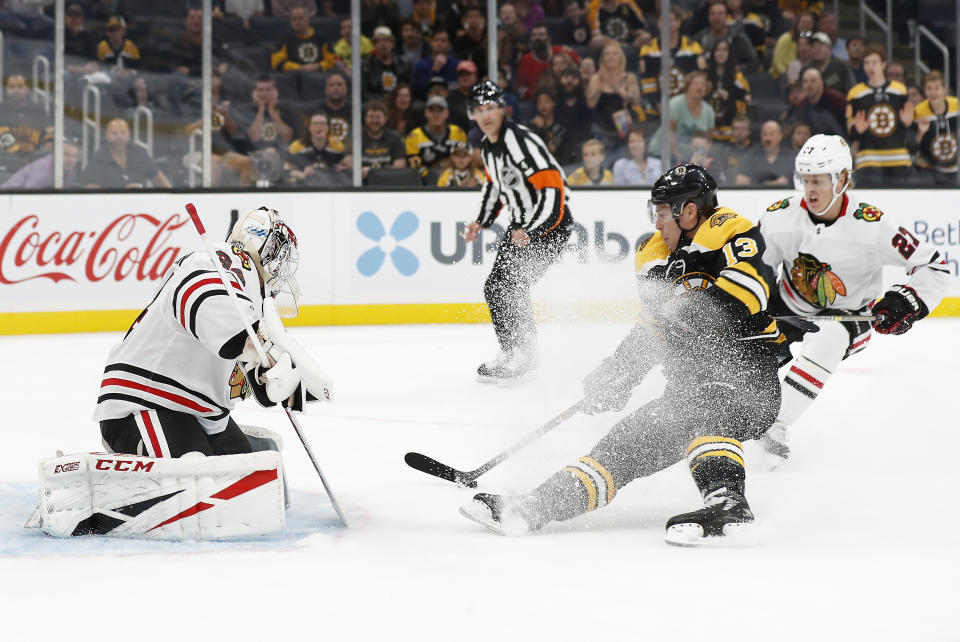 Boston Bruins' Charlie Coyle looses an edge as he moves in to score on Chicago Blackhawks goaltender Kevin Lankinen during the first period of an NHL preseason hockey game Saturday, Sept. 28, 2019, in Boston. (AP Photo/Winslow Townson)