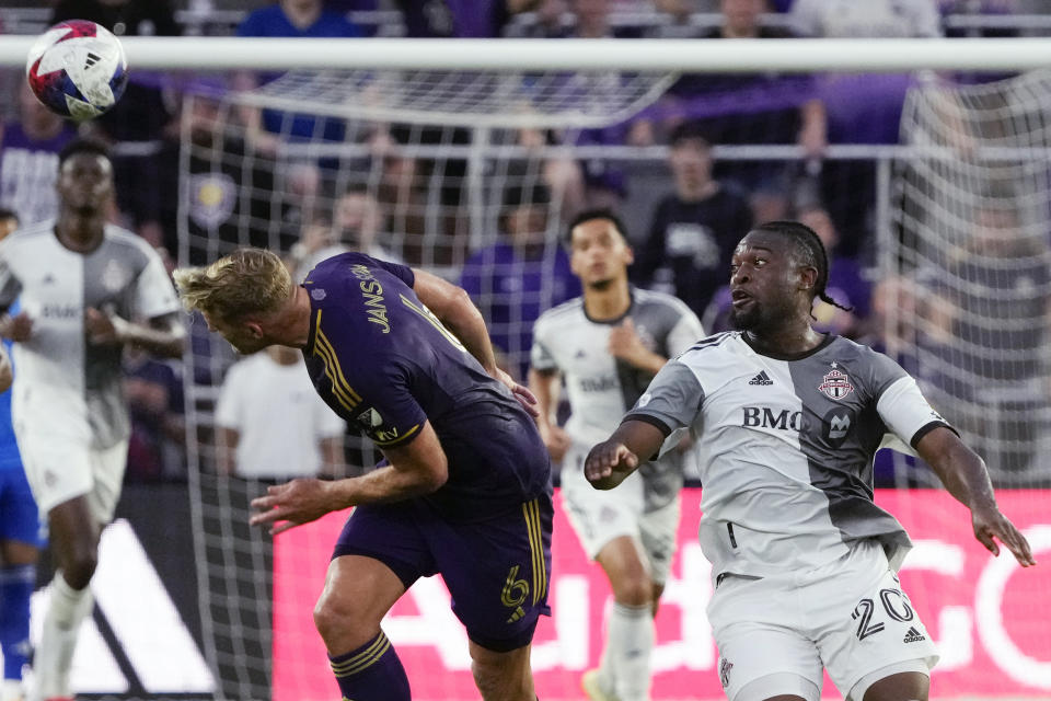 Orlando City's Robin Jansson (6) heads the ball away from Toronto FC's Ayo Akinola (20) during the first half of an MLS soccer match Tuesday, July 4, 2023, in Orlando, Fla. (AP Photo/John Raoux)