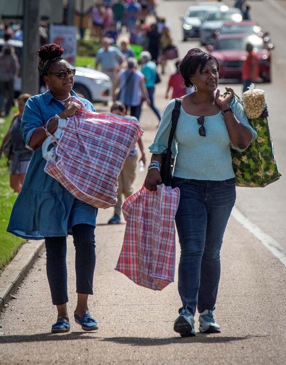 Long-time friends Yvette Foreman, left, of Waco, Texas, and Sabrina Walker, of Jackson were ready to call it a day after three-and-a-half hours of shopping at the Canton Flea Market Thursday, May 13, 2021. “I’m like a kid in a candy store,” Foreman said," being a first-time visitor to the event. Walker has attended to the Flea Market every year she remembers.