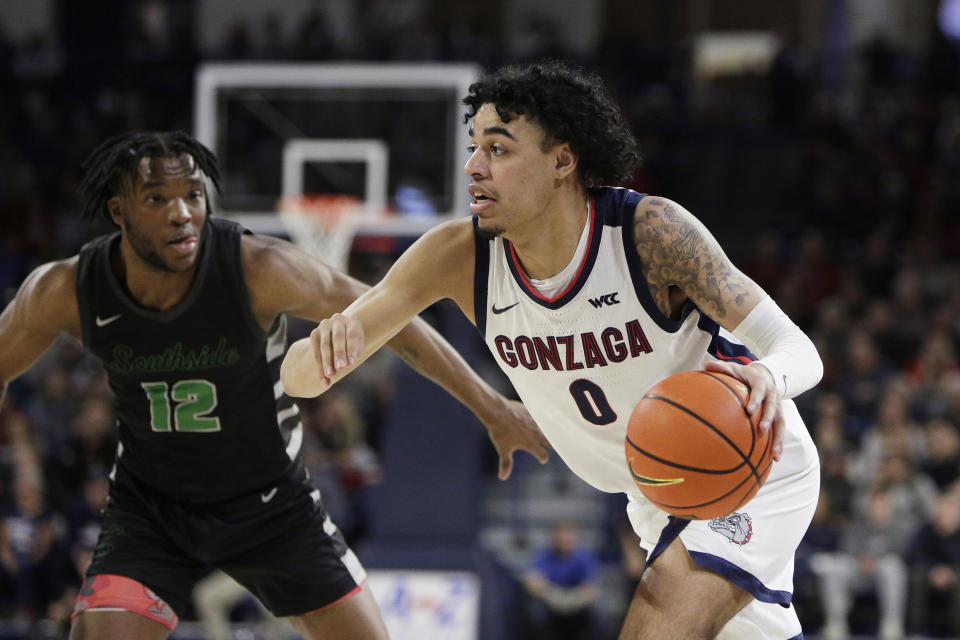 Gonzaga guard Julian Strawther (0) drives while defended by Chicago State guard Brent Davis (12) during the second half of an NCAA college basketball game, Wednesday, March 1, 2023, in Spokane, Wash. Gonzaga won 104-65. (AP Photo/Young Kwak)