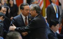 China's Foreign Minister Wang Yi (L) shakes hands with Thailand's Foreign Minister Don Pramudwinai during the ASEAN-China meeting in Vientiane on July 25, 2016