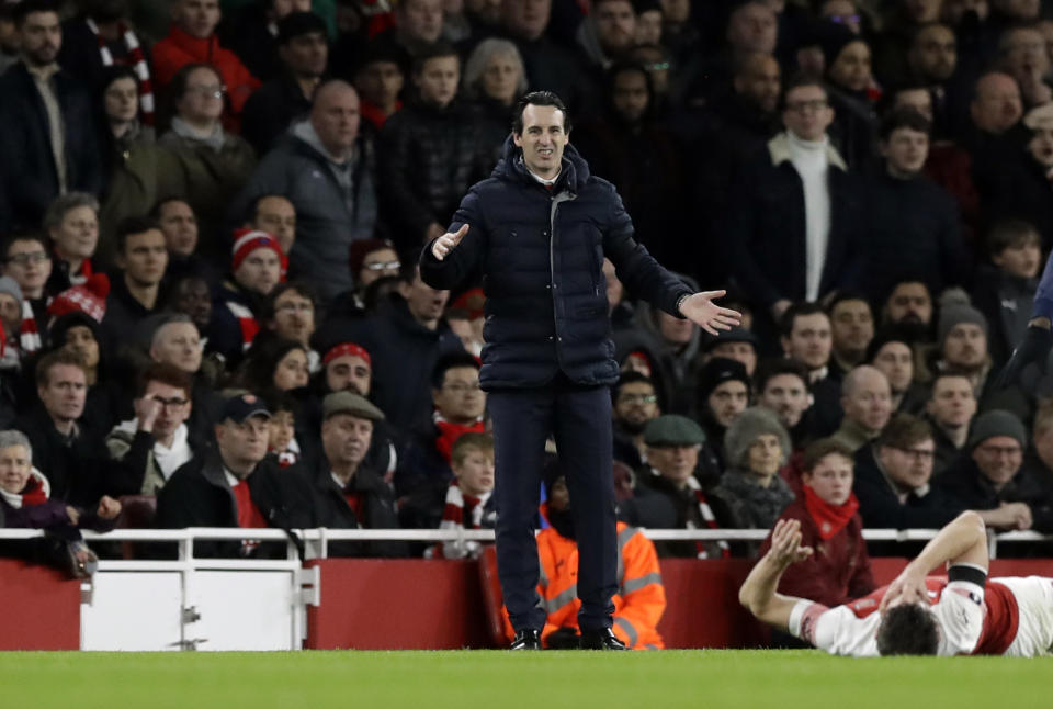 Arsenal's head coach Unai Emery, center, looks Arsenal's Laurent Koscielny lies on the pitch during the English FA Cup fourth round soccer match between Arsenal and Manchester United at the Emirates stadium in London, Friday, Jan. 25, 2019. (AP Photo/Matt Dunham)