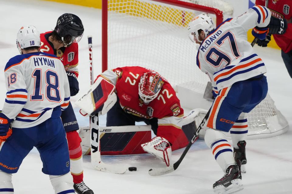 Jun 8, 2024; Sunrise, Florida, USA; Edmonton Oilers forward Connor McDavid (97) reaches for the puck against Florida Panthers goaltender Sergei Bobrovsky (72) during the third period in game one of the 2024 Stanley Cup Final at Amerant Bank Arena. Mandatory Credit: Jim Rassol-USA TODAY Sports