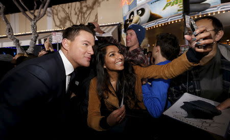 Cast member Channing Tatum poses with a fan at the premiere of "Hail, Caesar!" in Los Angeles, California February 1, 2016. The movie opens in the U.S. on February 5. REUTERS/Mario Anzuoni