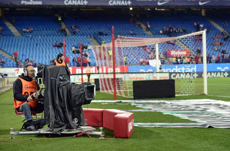 A TV cameraman works during the Spanish league football match Club Atletico de Madrid vs Valencia CF at the Vicente Calderon stadium in Madrid on March 8, 2015