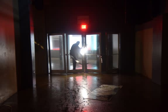 A man passes through a door at Roberto Clemente Coliseum in San Juan, Puerto Rico, which suffered damages from wind on September 20, 2017.