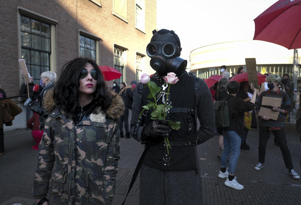 Sex workers protest unequal treatment and stigmatizing during a demonstration in The Hague, Netherlands, Tuesday, March 2, 2021. Stores in one village opened briefly, cafe owners across the Netherlands were putting tables and chairs on their outdoor terraces and sex workers demonstrated outside parliament in protests against the government's tough coronavirus lockdown. (AP Photo/Patrick Post)