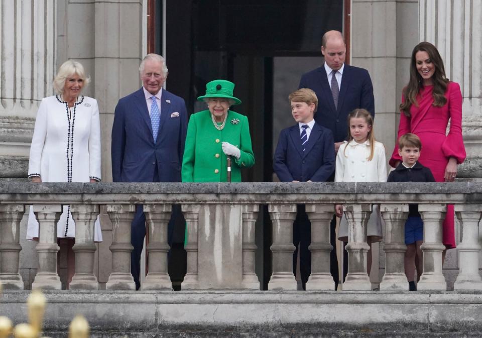 Camilla Duchess of Cornwall, Prince Charles, Queen Elizabeth II, Prince George, Prince William, Princess Charlotte, Prince Louis, and Kate Duchess of Cambridge appear on the balcony of Buckingham Palace during the Platinum Jubilee Pageant outside Buckingham Palace in London, Sunday June 5, 2022 (AP)