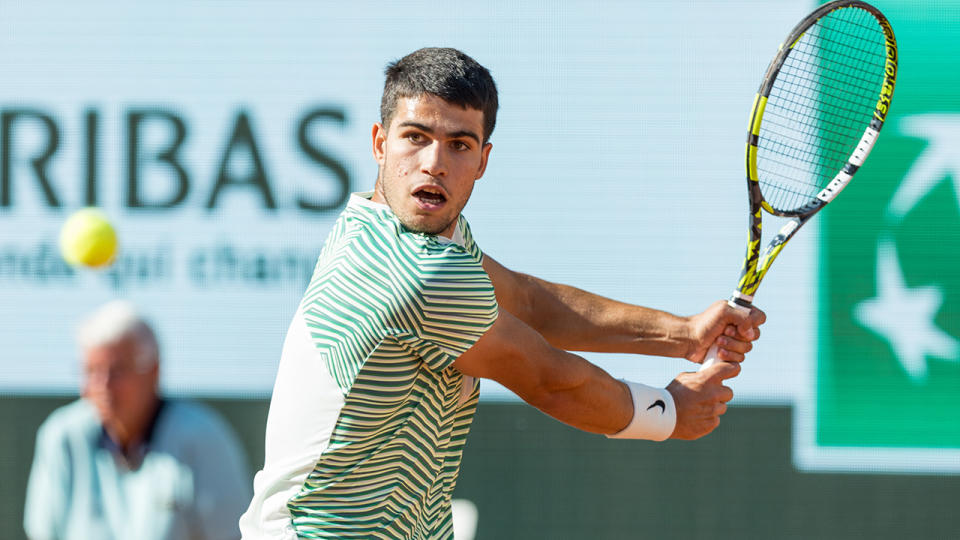 Carlos Alcaraz plays a backhand at the French Open.