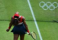 Serena Williams of the US celebrates her victory over Russia's Maria Sharapova at the end of their final tennis match as part of the 2012 London Olympic Games at the All England Tennis Club in Wimbledon, southwest London, on August 4, 2012. Williams won 6-0, 6-1