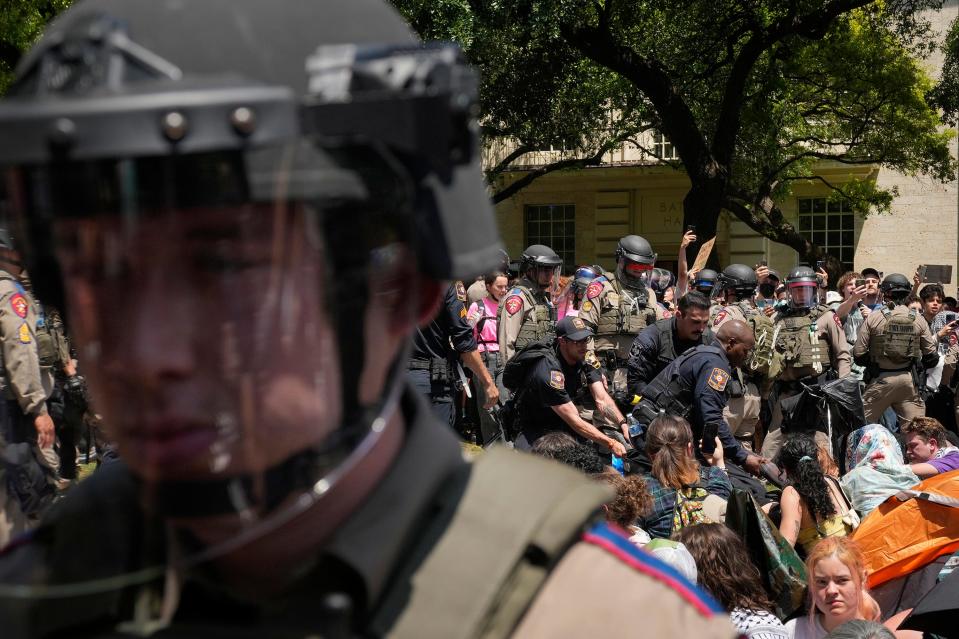 Police backed by Texas Department of Public Safety troopers arrest protesters at the University of Texas campus April 29.