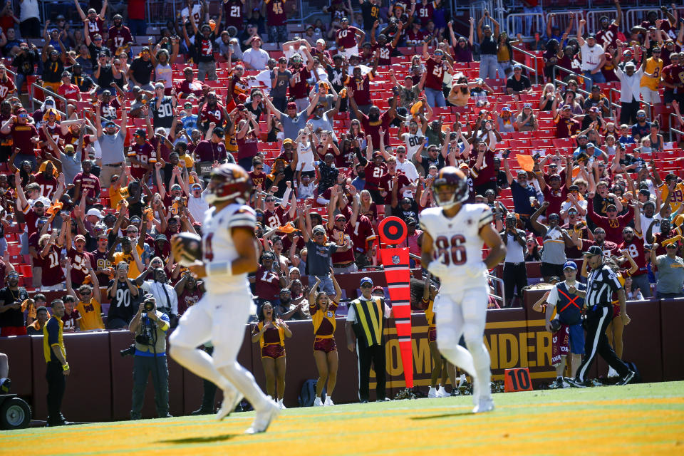 Washington Commanders fans celebrates after Sam Howell scored a touchdown against the Carolina Panthers during the second half of an NFL preseason football game Saturday, Aug. 13, 2022, in Landover, Md. (Shaban Athuman/Richmond Times-Dispatch via AP)