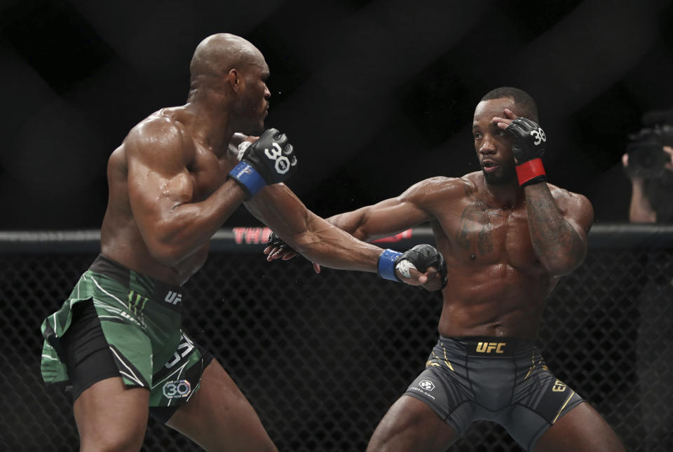 Leon Edwards, right, faces off against Kamaru Usman during their welterweight title bout at the UFC 286 mixed martial arts event Saturday March 18, 2023, in London. (Kieran Cleeves/PA via AP)