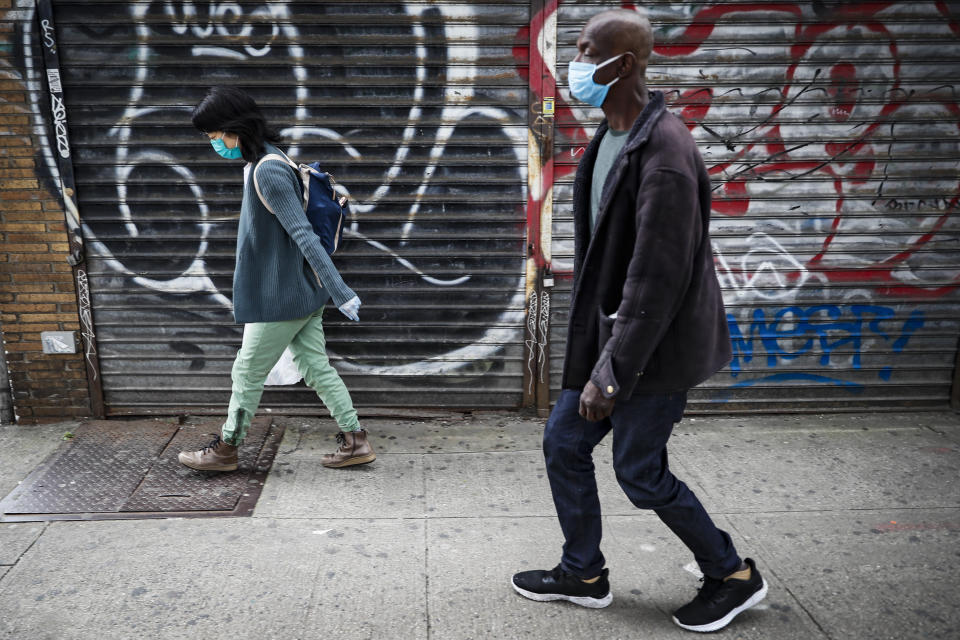 Dr. Jeanie Tse, chief medical officer at the Institute for Community Living, left, walks with her patient Aubrey O. 57, right, to her offices after administering a dose of antipsychotic medication to treat his schizophrenia, Wednesday, May 6, 2020, in the Brooklyn borough of New York. Even before the pandemic, access to mental health services in the U.S. could be difficult, including for people with insurance. Now experts fear COVID-19 will make the situation worse. (AP Photo/John Minchillo)