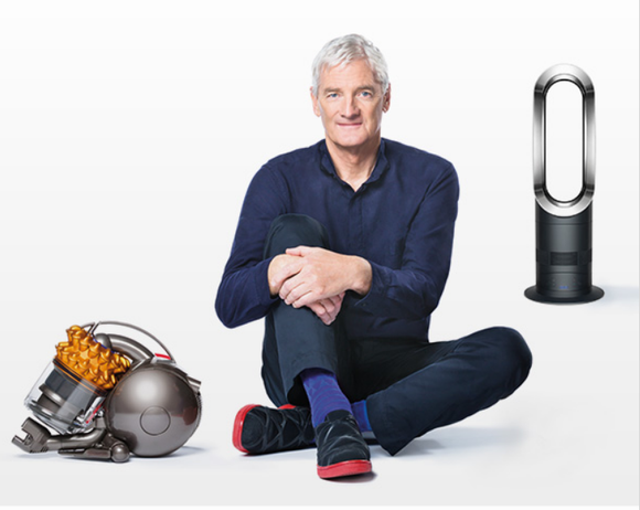 Founder James Dyson sitting amidst two of the company's products -- a vacuum and an air purifier.