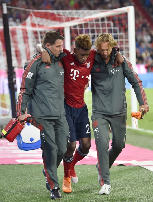 Bayern Munich's French forward Kingsley Coman (C) faces another lengthy spell on the sidelines after tearing ankle ligaments for the second time in 2018 on Friday