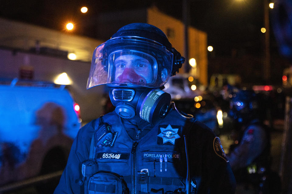 Police stand guard during protests, Friday, Sept. 18, 2020, in Portland, Ore. The protests, which began over the killing of George Floyd, often result frequent clashes between protesters and law enforcement. (AP Photo/Paula Bronstein)