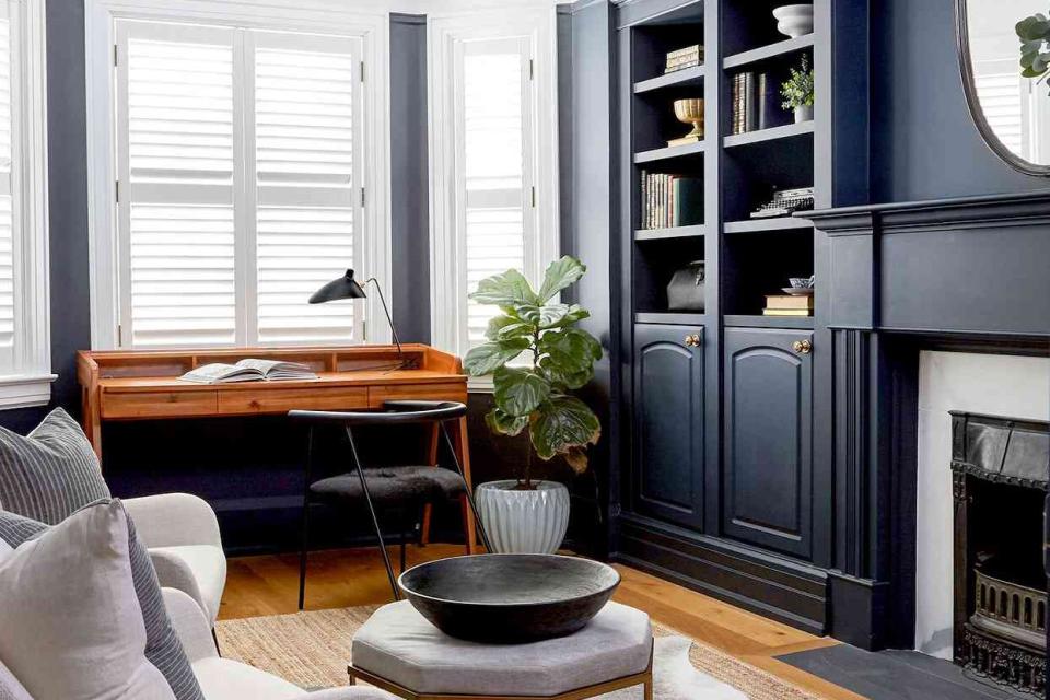 Office with dark blue shelving