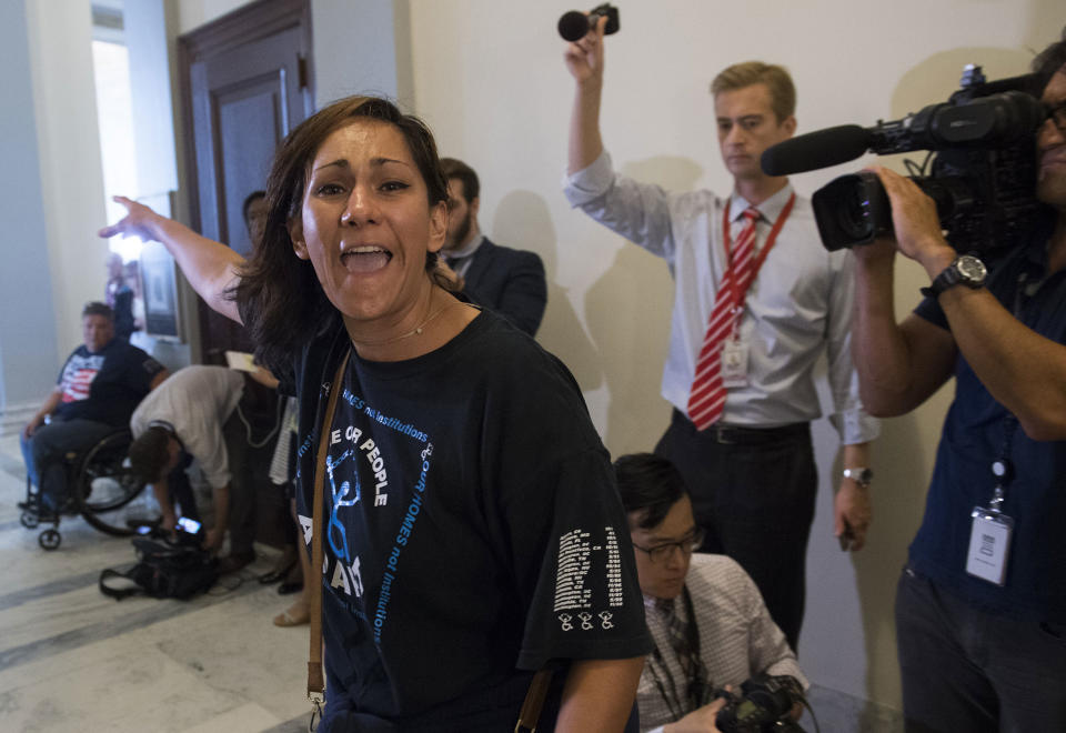 <p>A protestor against the Senate Republican’s draft healthcare bill shouts outside the office of Senate Majority Leader Mitch McConnell, Republican of Kentucky, on Capitol Hill in Washington, June 22, 2017. (Photo: Saul Loeb/AFP/Getty Images) </p>