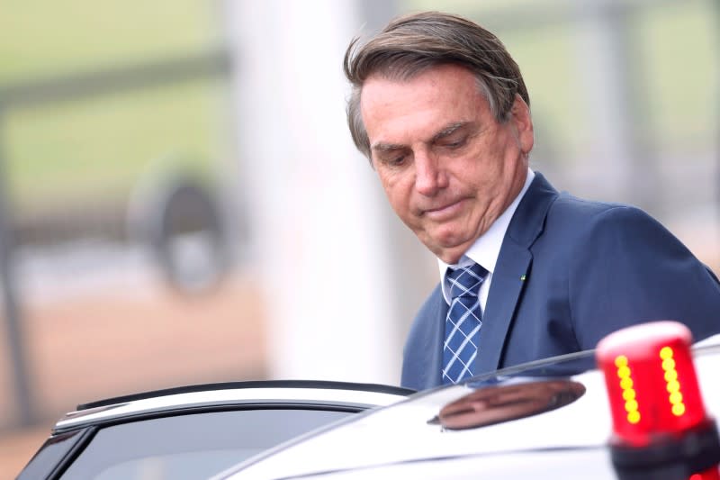 Brazil's President Jair Bolsonaro looks on as he leaves the Alvorada Palace in Brasilia