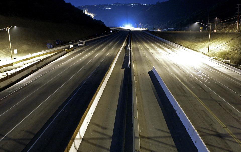 Interstate 405 is completely free of traffic, seen looking southbound from the Skirball Drive bridge, in preparation for the demolition of the Mulholland Drive bridge, just after midnight early Saturday morning, July 16, 2011. (AP Photo/Reed Saxon)