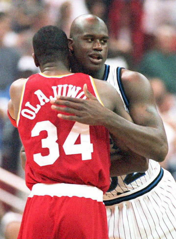 Orlando Magic center Shaquille O'Neal hugs Houston Rockets center Hakeem Olajuwon prior to the start of the first game of the NBA championships at the Orlando Arena. (CALVIN KNIGHT/AFP/Getty Images)