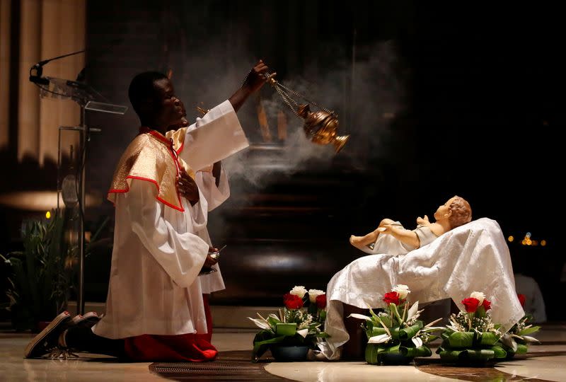 Altar boys attend the celebration of Christmas at the Basilica Notre Dame in Yamoussoukro