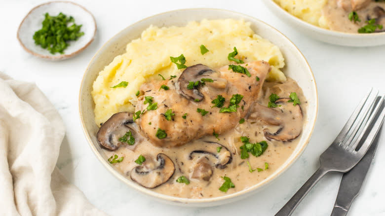 Bowl of chicken marsala with mashed potatoes