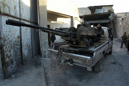 Free Syrian Army fighters take up position before firing toward forces loyal to Syria's President Bashar al-Assad at the Aleppo international airport frontline February 7, 2014. REUTERS/Ammar Abdullah