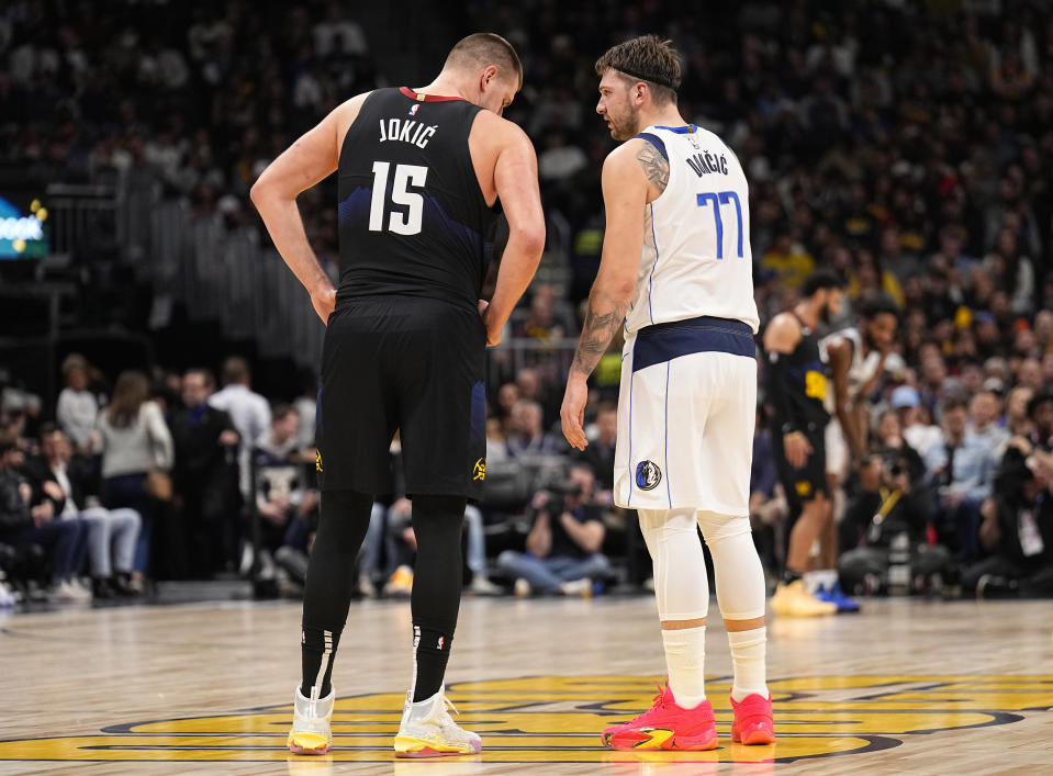 Denver Nuggets center Nikola Jokic (15) and Dallas Mavericks guard Luka Doncic (77) talk during the second quarter of an NBA basketball game Monday, Dec. 18, 2023, in Denver. (AP Photo/Jack Dempsey)