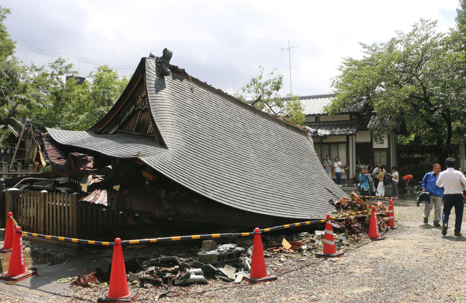 Worship hall of Taishogun-jinja Shrine tumbles down after Typhoon Cimarron hit the area in Kyoto, western Japan Friday Aug. 24, 2018. Typhoon Cimarron was back at sea and heading for northern Japan after crossing a swath of the western part of the country overnight, bringing heavy rain and high winds. (Kyodo News via AP)