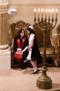 In this Saturday, Feb. 1, 2020, photo, Rabbi Jacqueline Mates-Muchin smiles at Hanna Raskin during her bat mitzvah at Temple Sinai in Oakland, Calif. Since an anti-semitic graffiti incident at the temple in 2017 and the subsequent deadly attacks on synagogues in Pittsburgh and in Poway, Calif., Mates-Muchin says there’s extra worry as she feels obliged to be constantly mindful of her congregation’s safety. (AP Photo/Noah Berger)