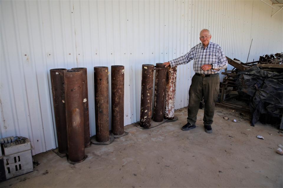 Fireworks enthusiast Tommy Bolack stands next to some of his 8-inch mortar tubes to be used for his annual Fourth of July show from the B-Square Ranch.