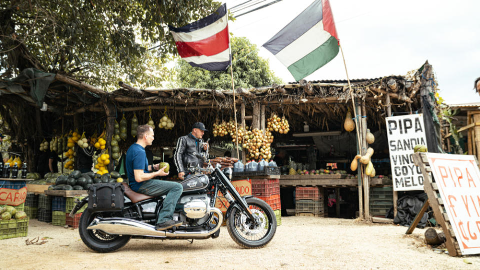 A pit stop to beat the heat with fresh coconut water and fruit. - Credit: Hermann Koepf, courtesy of BMW Motorrad.