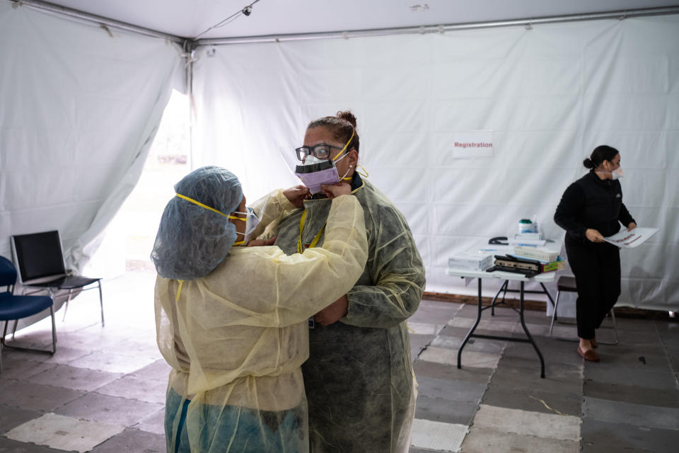 NEW YORK, NY - MARCH 20: Nurses adjust protective masks inside a testing tent at St. Barnabas hospital on March 20, 2020 in New York City. St. Barnabas hospital in the Bronx set-up tents to triage possible COVID-19 patients outside before they enter the main Emergency department area. (Photo by Misha Friedman/Getty Images)