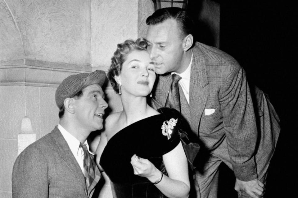 Katie Boyle with comedians Norman Wisdom and Al Read at the London Palladium in 1954 (PA)