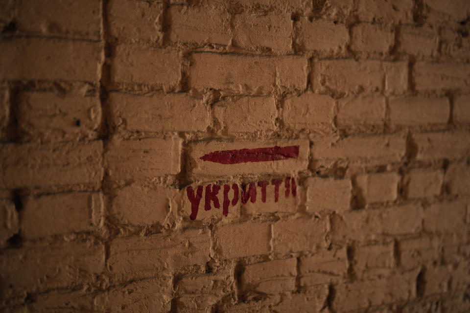 FILE - A signs reads "shelter" in a street of Kyiv, Ukraine, Saturday, March 11, 2023. When air raid alarms sound in Ukraine, they also trigger a downloadable app that has been voiced by “Star Wars” actor Mark Hamill. With his gravely but also calming baritone, he urges people to take cover. He also tells them when the danger has passed, signing off with “May the Force be with you.” In an interview with The Associated Press, the actor said he’s admiring Ukraine's resilience from afar in California. (AP Photo/Thibault Camus, File)