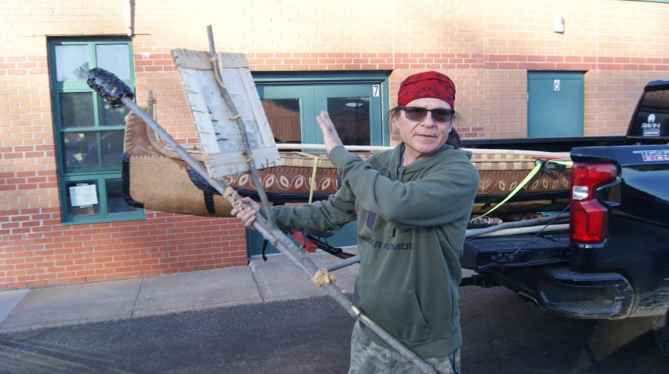 Wayne Valliere prepares his handmade birchbark canoe and spear.