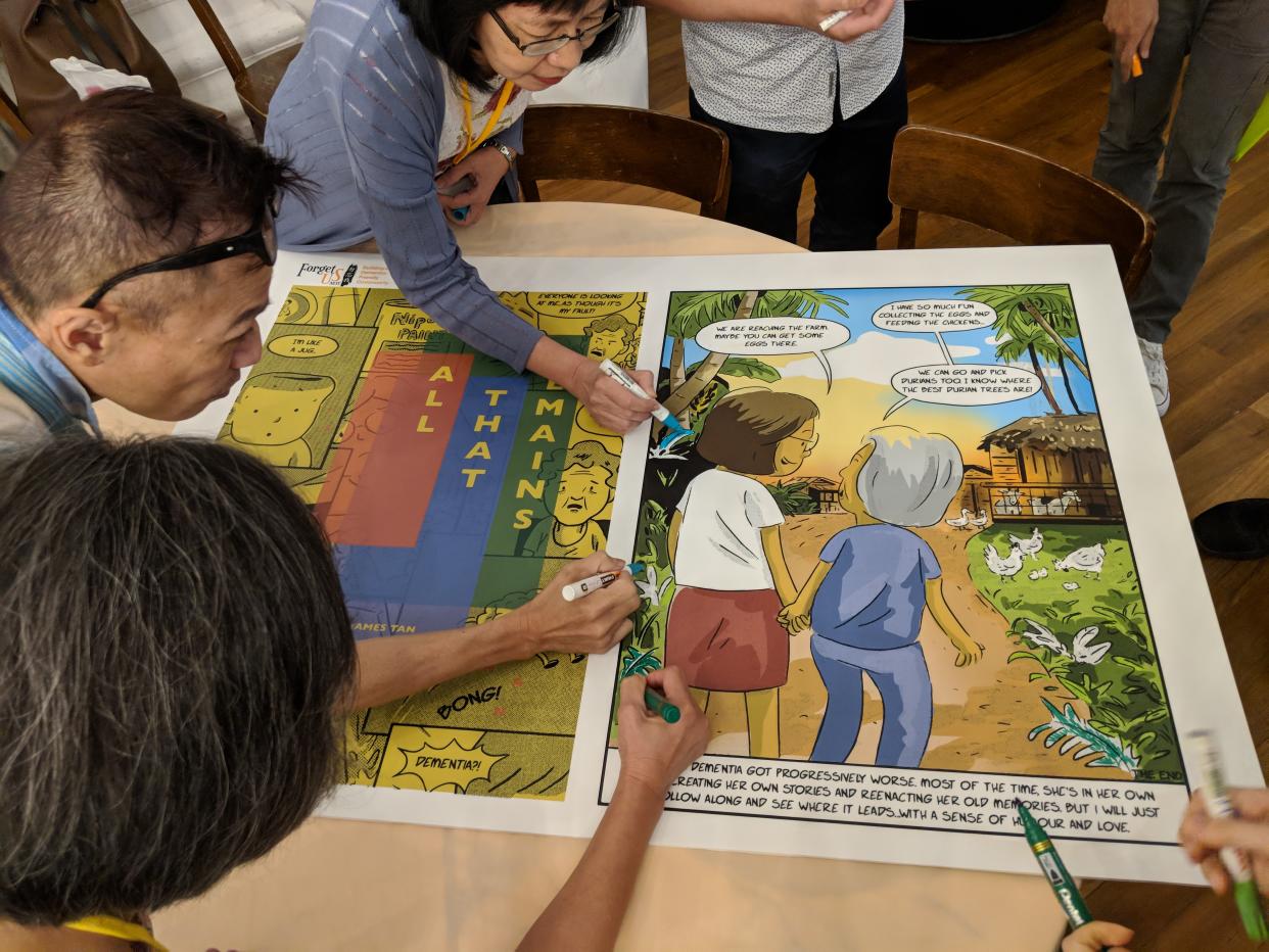 (Caregivers of persons with dementia seen on September 4, 2018, colouring a panel in “All That Remains”, a 72-page graphic novel that draws on personal encounters with the disease. PHOTO: Wong Casandra/Yahoo News Singapore)