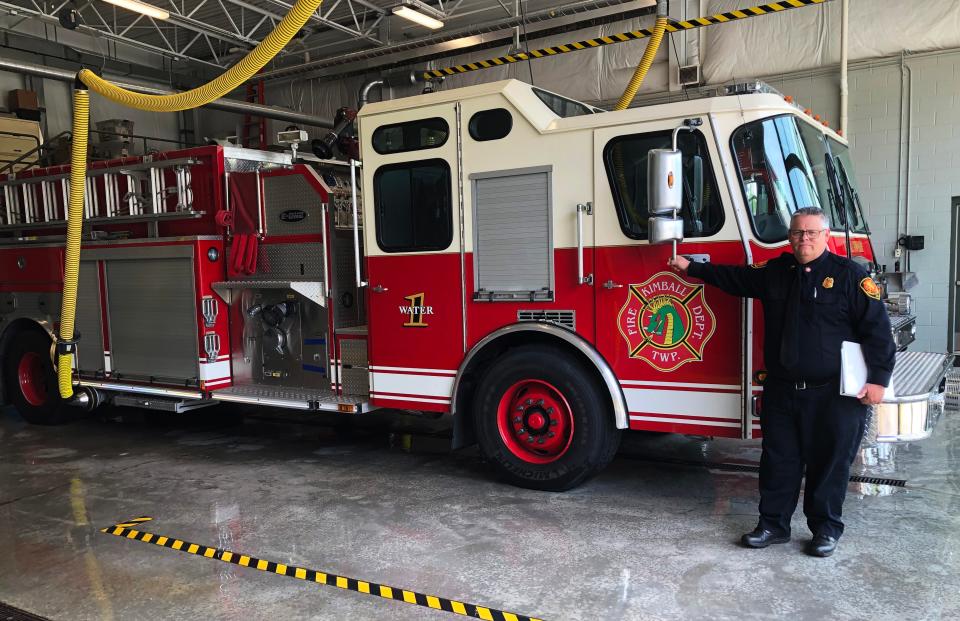 Kimball Township Fire Chief Ed Gratz stands in front of a firetruck parked inside the Kimball Township Fire Department on Allen Road in Kimball Township on Monday, May 23, 2022.