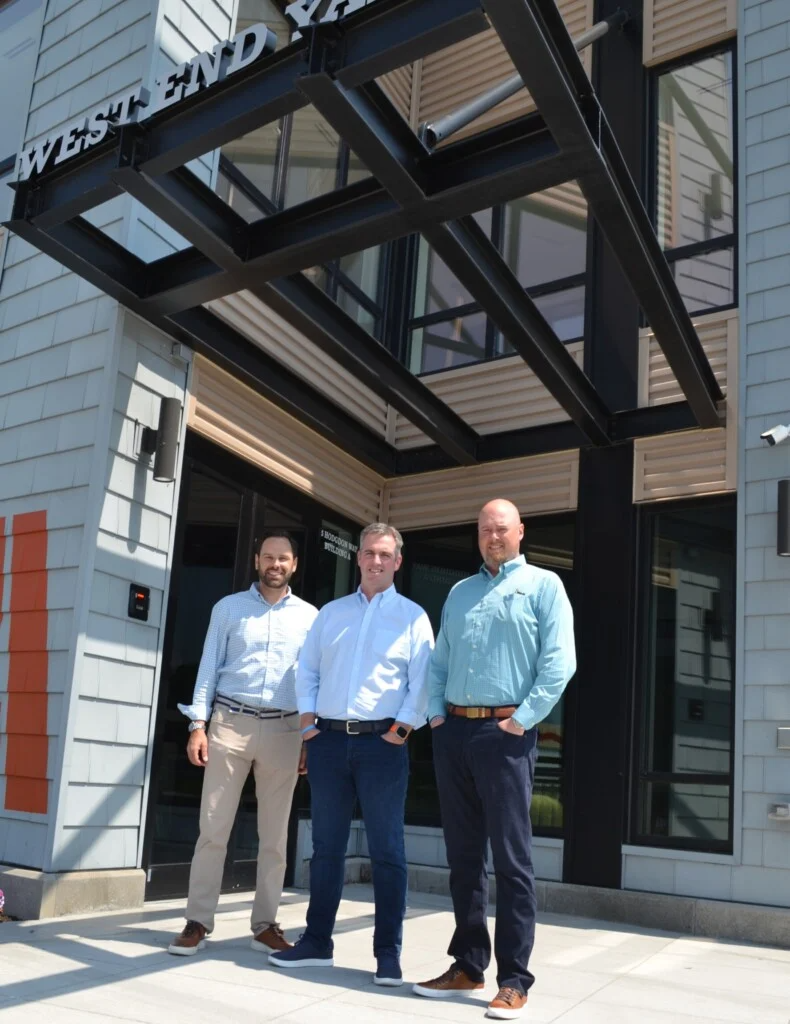 Torrington Properties, which has invested upwards of $500 million in New Hampshire properties so far, has added the Mill Plaza in Durham to its portfolio. Pictured here, at West End Yards in Portsmouth, another of Torrington’s projects, is, from left, CEO Jay Bisognano, COO Matt Morgan and Brett Pagani, head of capital markets.