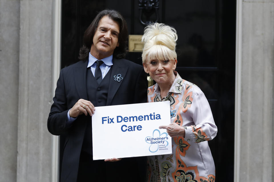 British actress Barbara Windsor (R) and her husband Scott Mitchell pose outside 10 Downing Street as she delivers a petition calling for urgent action on dementia care on September 2, 2019. (Photo by Tolga AKMEN / AFP) (Photo credit should read TOLGA AKMEN/AFP via Getty Images)