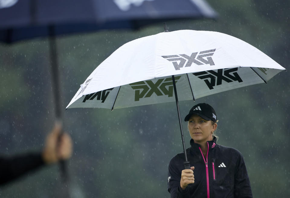 Linnea Strom, of Sweden, holds an umbrella while waiting to tee off on the 17th hole during the first round of the LPGA Portland Classic golf tournament in Portland, Ore., Thursday, Aug. 31, 2023. (AP Photo/Craig Mitchelldyer)