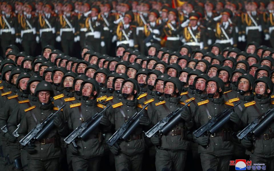 Thousands of troops marched alongside the weapons, none of them wearing masks - KCNA/Reuters