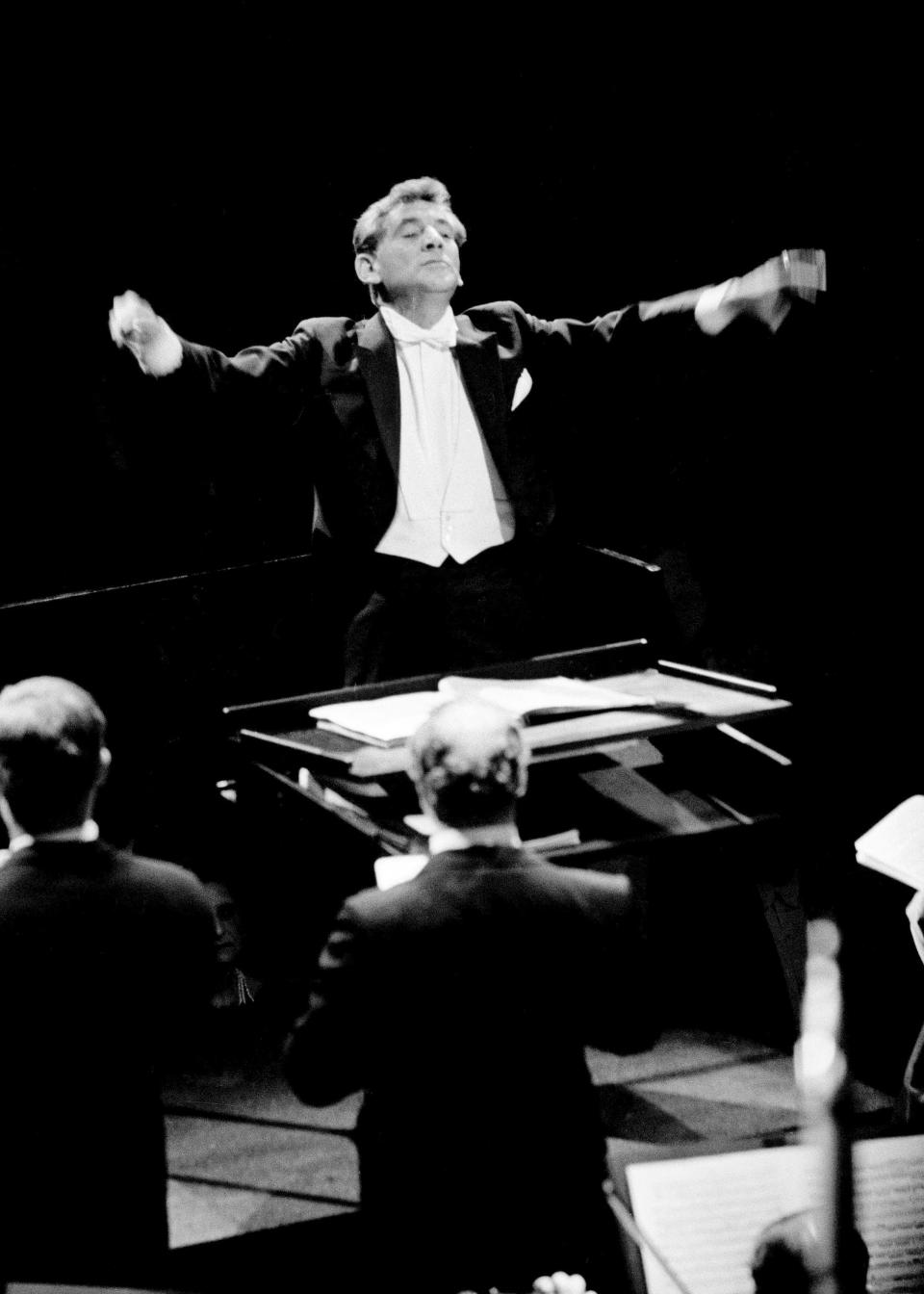 Leonard Bernstein conducts the New York Philharmonic at the opening of Philharmonic Hall in Manhattan, Sept. 23, 1962. For his role as Leonard Bernstein in "Maestro," Bradley Cooper learned from top conductors and by stealth in concert halls or from the orchestra pit.
