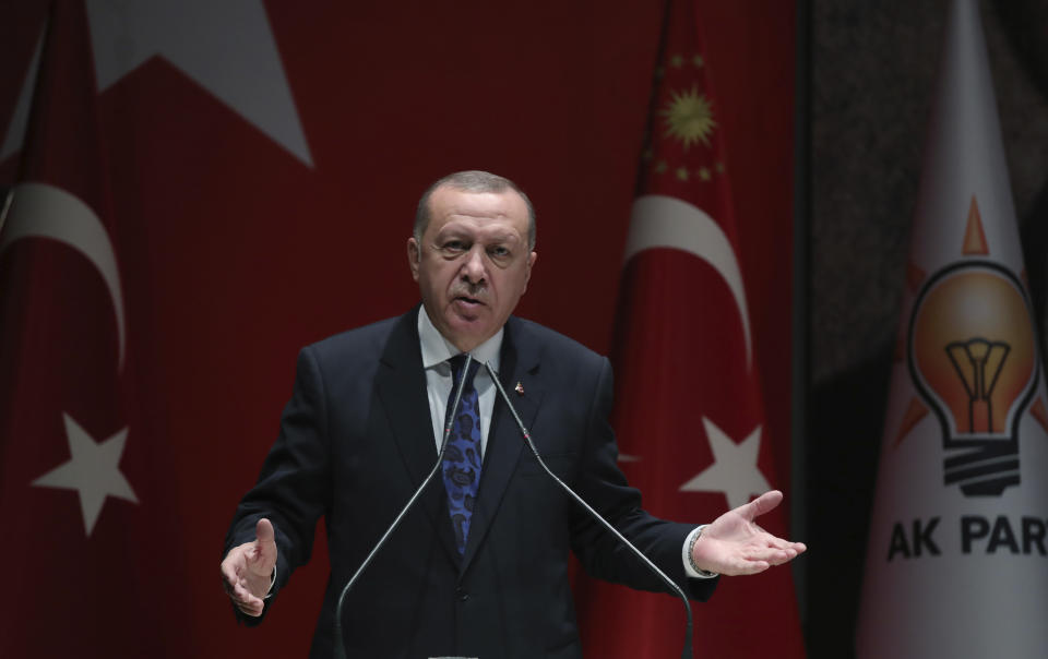 Turkey's President Recep Tayyip Erdogan addresses the members of his ruling party, in Ankara, Turkey, Thursday, Dec. 26, 2019. Erdogan says Thursday his government will submit a bill to parliament that would allow Turkey to send troops to Libya, in support of the U.N.-backed government there. Erdogan said the Libyan government, which controls the capital, Tripoli, has "invited" Turkey to send troops. (Turkish Presidency via AP, Pool)