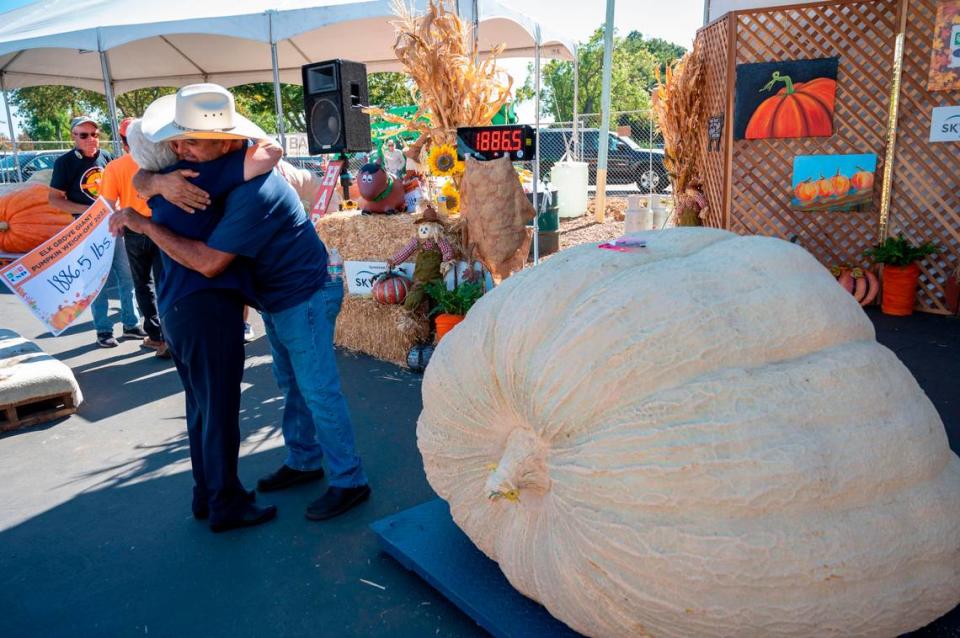 Napa County grower Jose Ceja gets a big hug from his mom, Carmen Barragan, after winning the giant pumpkin contest Saturday, Oct. 1, 2022, at the annual Elk Grove Giant Pumpkin Festival. His pumpkin weighed in at 1,886 pounds, earning him $7,000.