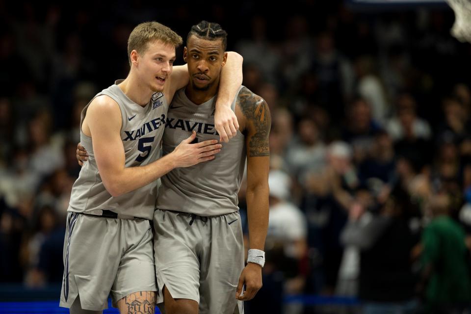 Xavier Musketeers guard Adam Kunkel (5) embrases Xavier Musketeers guard Paul Scruggs (1) in the second half of the NCAA men's basketball game on Friday, Nov. 12, 2021, at the Cintas Center in Cincinnati. Xavier Musketeers defeated Kent State Golden Flashes 73-59.