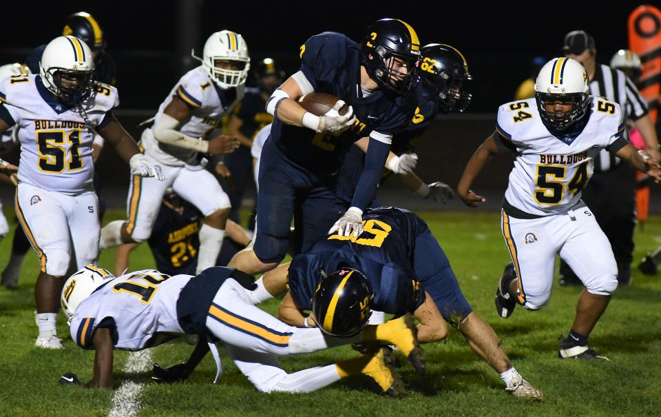 Brett Moore of Airport runs against Detroit East English during a 70-18 Airport rout in a Division 4 playoff game on Friday, October 27, 2023.