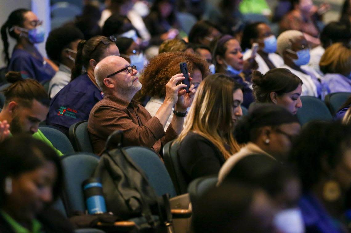A man takes a photo with his cellphone during a conference about school safety and mental wellness at Ronald W. Reagan Doral Senior High School, in Doral, Florida, on Wednesday, Aug. 3, 2022.